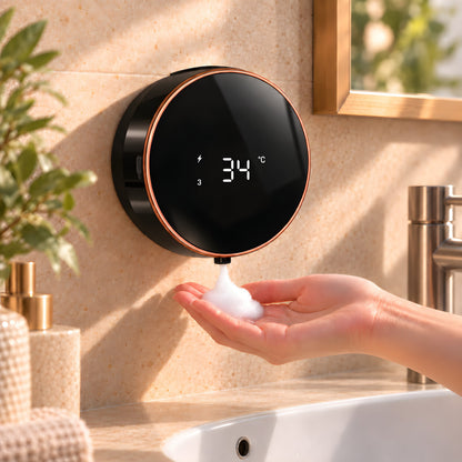 Black FoamHalo wall-mounted automatic foaming soap dispenser releasing foam into an open hand.
