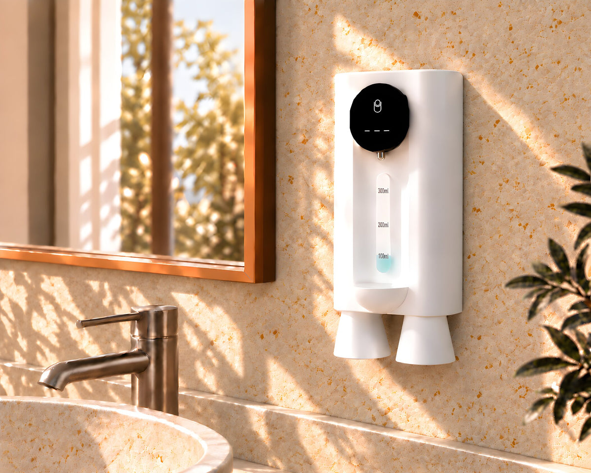 White MintWave wall-mounted mouthwash dispenser with two cups above a bathroom sink.